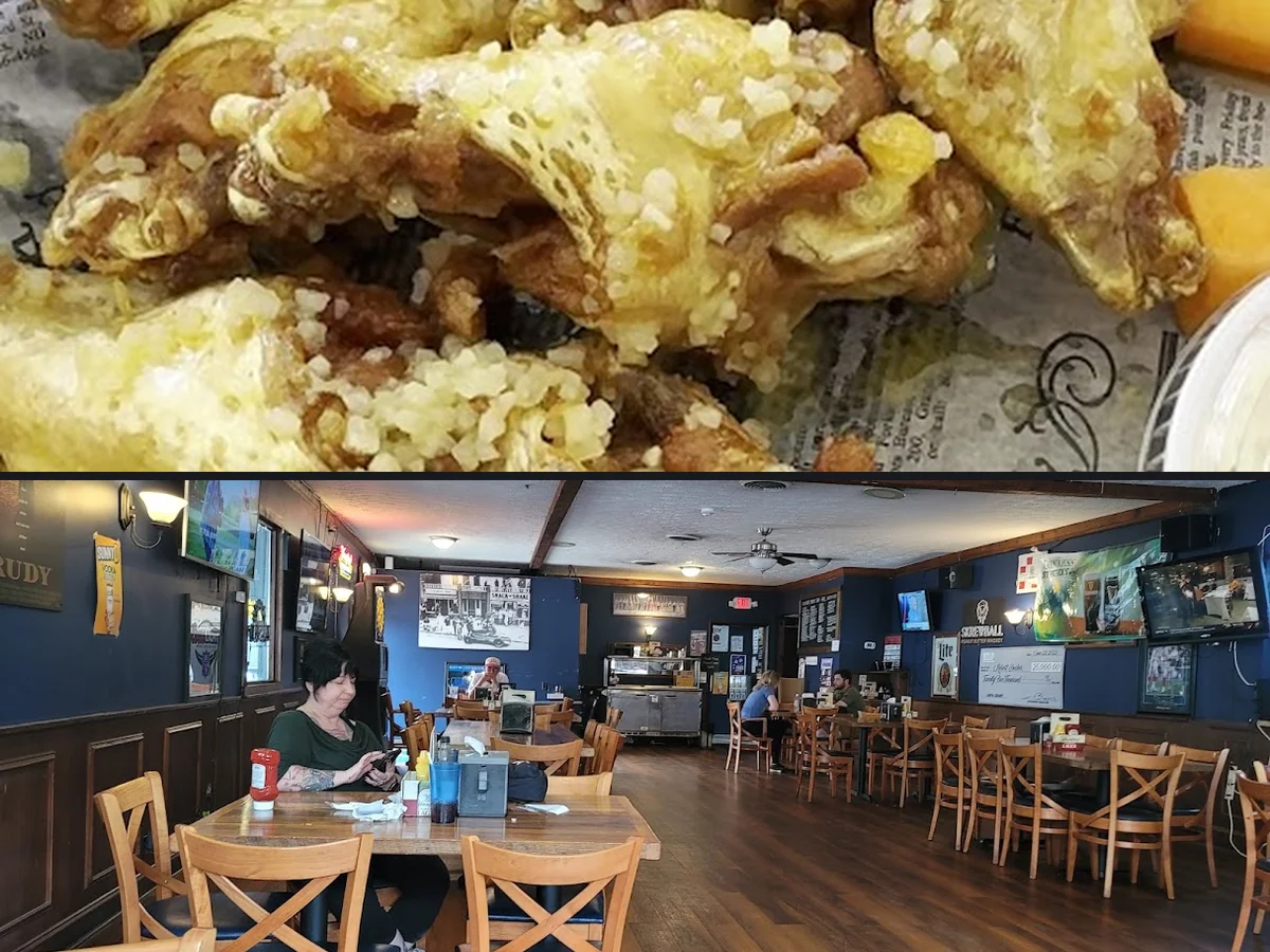 Wood-paneled sports bar with mounted screens.